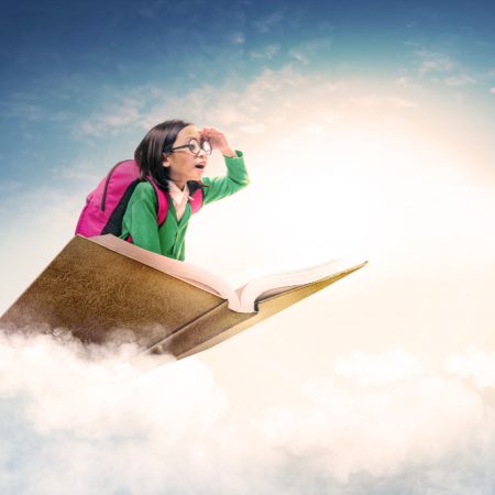 asian-cute-girl-with-glasses-and-backpack-sitting-on-the-book-with-blue-sky