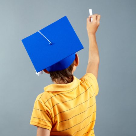 rear-view-of-schoolboy-writing